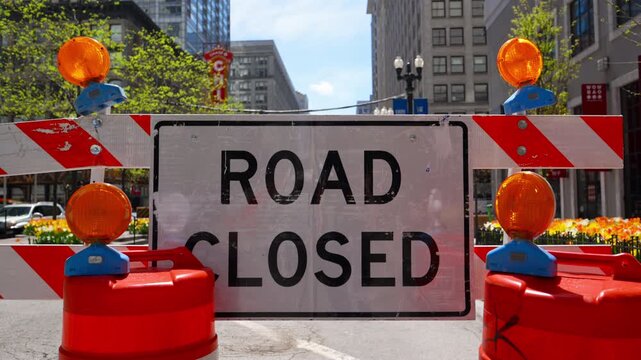 Blocked road with barricades and warning sign ROAD CLOSED showing restricted access and construction area in the city. Wide view Close up