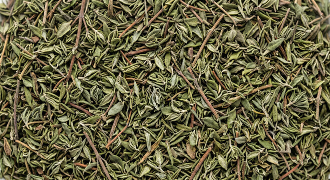 A detailed overhead view of dried thyme sprigs and leaves a fragrant herb with a muted green color and delicate texture commonly used in cooking and seasoning various dishes