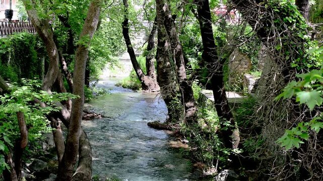 Static shot footage shows water flowing of the Herkyna river at Livadia city in Boeotia-Greece.