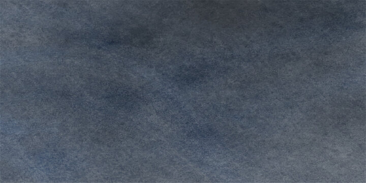 A closeup macro shot of a rough dark blue denim textile surface shows the textured pattern of a cotton fabric material backdrop for fashion design wallpaper