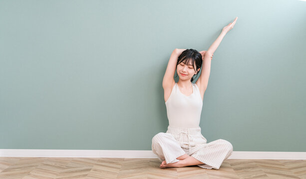 Asian woman stretching and deep breathing at home (hair removal, yoga)