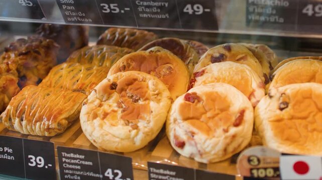 Assorted Fresh Pastries and Breads Displayed in a Modern Bakery Case