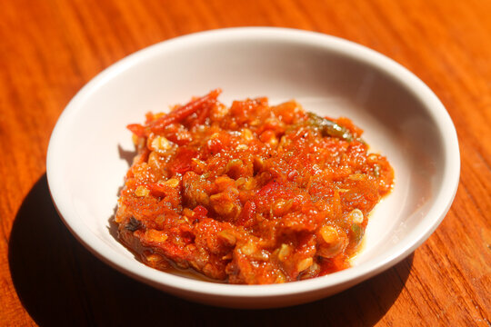 Closeup view of a bowl of authentic Indonesian Sambal Terasi, a bold and fiery chili paste enriched with fermented shrimp paste.