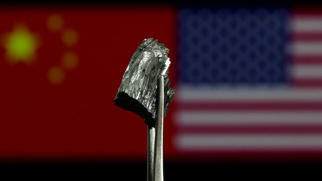 Tellurium rare earth chunk rotating in front of USA and China national flags