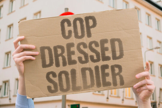 "Cop Dressed Soldier" Police officers routinely wear military-grade tactical gear in civilian settings. POLICE. MILITARY. TACTICAL. GEAR. CIVILIAN.