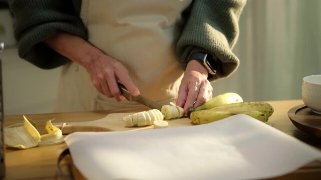 Senior woman cooking healthy meal at home, highlighting wellness, active aging, and independent living. Reflects nutrition, healthy eating, home cooking, senior lifestyle, and wellbeing.