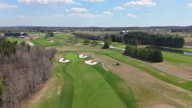 Sweeping view of TPC Toronto golf course with vibrant fairways and strategic sand bunkers. Ideal for promotional use or golf-related content.