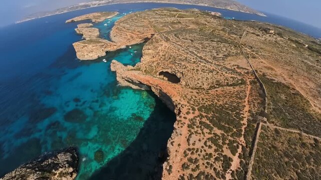 Ultra wide shot from a drone flying over Comino island towards the Blue Lagoon