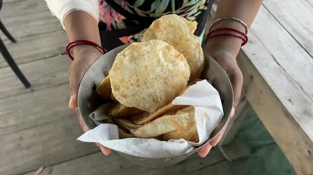 Dal puri held by a woman in beach in Digha, West Bengal.