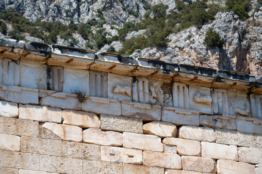 Classical frieze detail on marble building at Delphi
