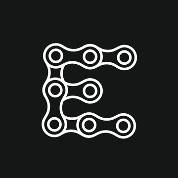 White Letter E Outline from Bicycle Chain Links on Black Background
