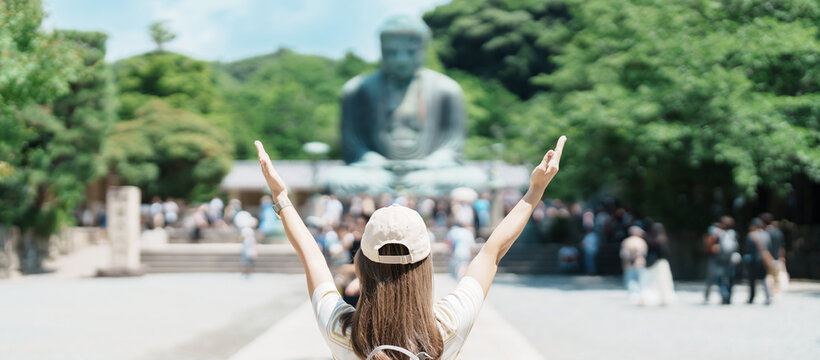 Woman tourist Visiting in Kamakura, Kanagawa prefecture , Japan. happy Traveler sightseeing the Great Buddha statue. Landmark and popular for tourists attraction near Tokyo. Travel and Vacation