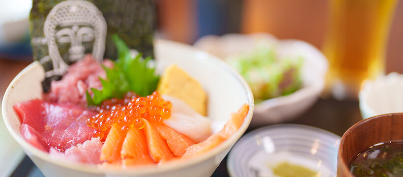 sashimi mixed fresh set japanese food with rice bowl. Salmon, Tuna fish, seafood and wasabi in restaurant. Kamakura Food with Buddha face is famous in Kangawa prefecture, Japan