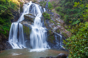 Obraz premium Krung Ching Waterfall is a beautiful waterfall nestled amidst lush rainforest in Khao Luang National Park, Nakhon Si Thammarat Province, Thailand.