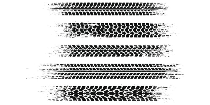 Set of black tire tracks and vehicle wheel marks on the road