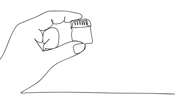 Hand holding a microSD to SD card adapter