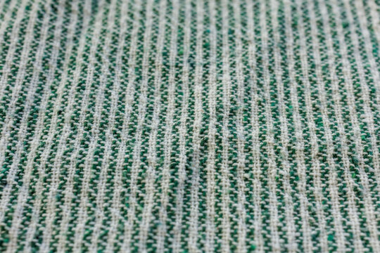 Macro perspective of green and white woven cotton towel texture