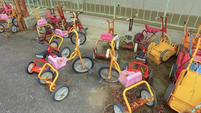 Eerie tracking shot of forgotten playground equipment fading into disrepair.