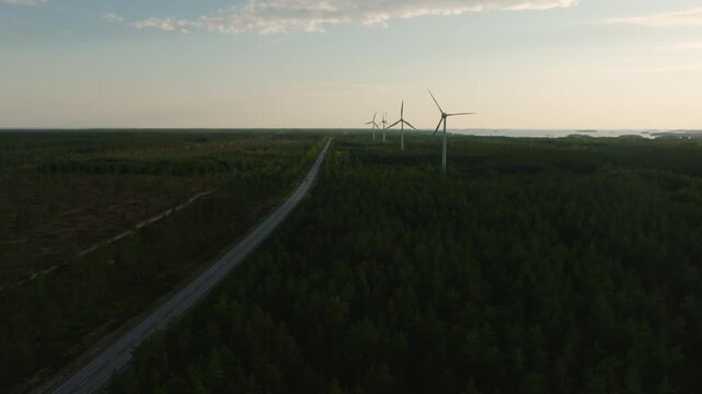 Aerial view of wind power along a road in the Hanko peninsula, sunset in Finland