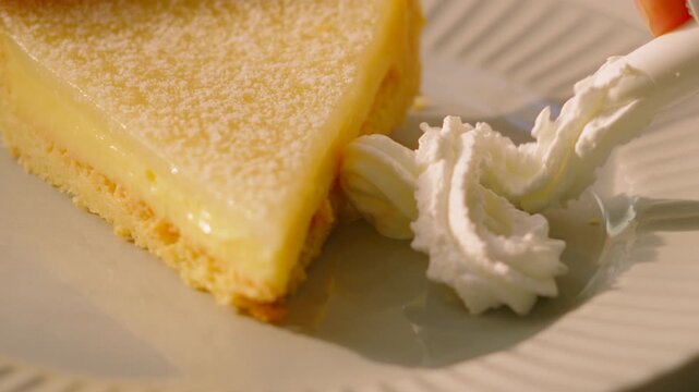 Whipped Cream Placed on Plate with Classic French Tarte au Citron on a Plate in Natural Light. Perfect for Food apps, social media montages, high-end restaurant promos. 4K.