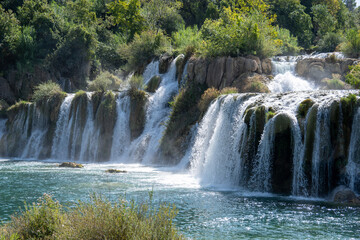 Waterfall cascades into river pool, Krka National Park, Croatia © Joseph Creamer