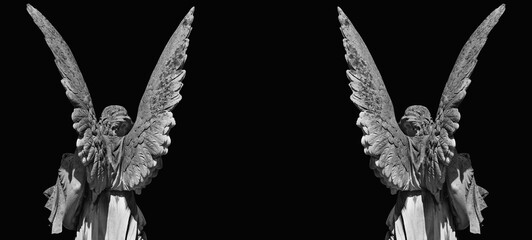 Naklejka premium Two dark angel statues forming gothic frame with copy space on black background