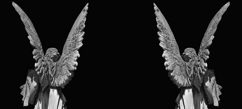 Two dark angel statues forming gothic frame with copy space on black background
