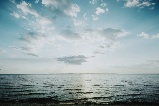 Sunny scenery of a lake in a windy day with a blue cloudy sky