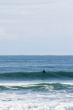 Surfer waiting for waves on ocean horizon