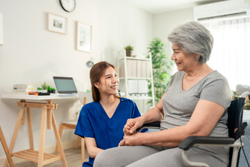 Fototapeta premium Asian caring caregiver look after senior woman patient at nursing home. 