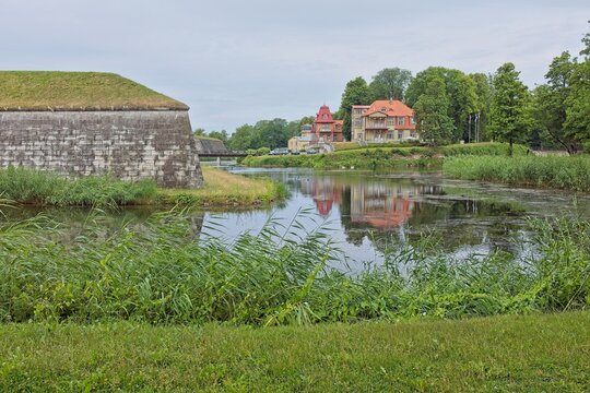 Stone structure on the left is part of the Kuressaarre castle's extensive fortification system, which includes bastions and walls surrounded by a moat.