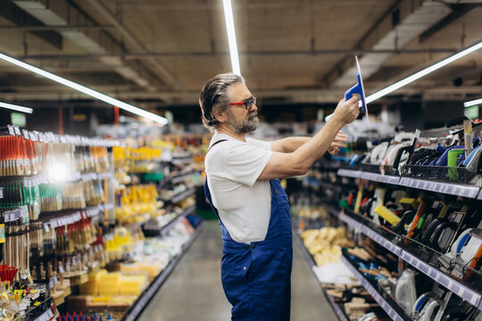 Man shopping for tiling tools in hardware store