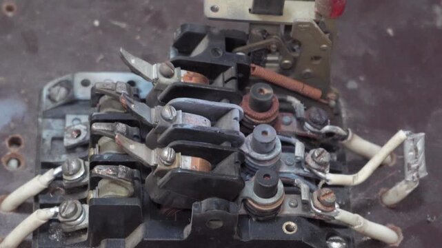 disassembled old electric industrial machine with electrical contactors, Close-up of a disassembled industrial automatic switch with old electrical contactors, power terminals and connected wires. Dus