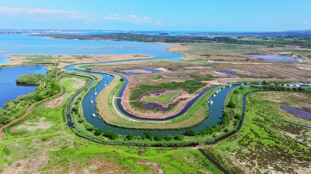 Aerial shot of the River Frome as it flows through roadbeds and into Poole Harbour near Wareham