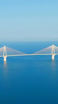 Vertical video. Patras, Greece. The Rio-Antirrio Bridge. Officially the Charilaos Trikoupis Bridge. Bridge over the Gulf of Corinth (Strait of Rion and Andirion). Drone footage