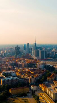 Vertical video. Milan, Italy. The famous skyscrapers of Milan are located around the botanical garden Campo di Fiori BAM. Milano Porta Garibaldi train station. Drone footage. Rich colors