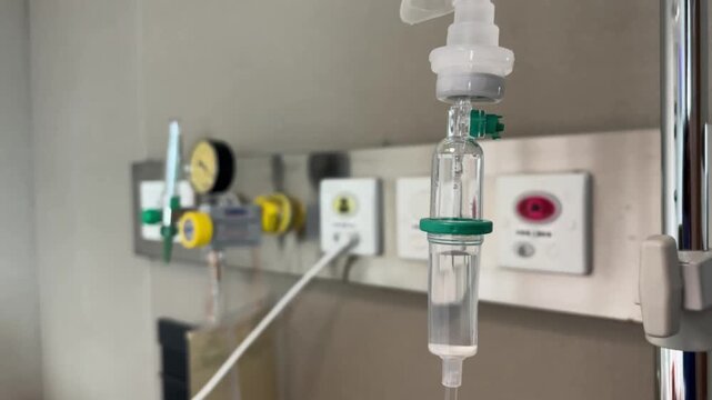 A close-up view of an IV drip and drip chamber containing lactated Ringer's solution in a hospital. Medical equipment for patient hydration and treatment, symbolizing patient health care.
