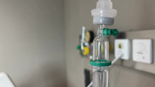 A close-up view of an IV drip and drip chamber containing lactated Ringer's solution in a hospital. Medical equipment for patient hydration and treatment, symbolizing patient health care.