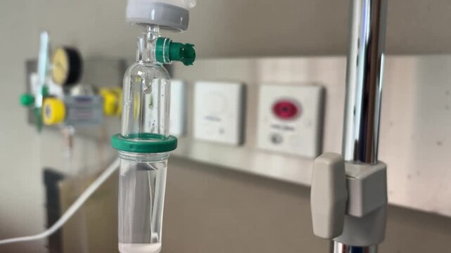 A close-up view of an IV drip and drip chamber containing lactated Ringer's solution in a hospital. Medical equipment for patient hydration and treatment, symbolizing patient health care.