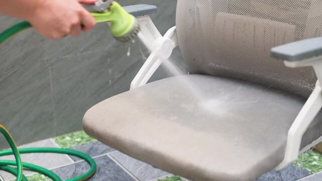 Cleaning mesh seat with garden hose effectively removes dust from breathable fabric. Strong water pressure penetrates upholstery ensure hygiene. Cleaning mesh seat process maintains furniture quality