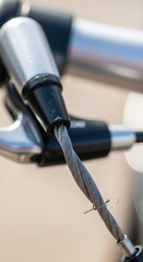 Naklejka premium Close-up of Bicycle Brake Cable and Handlebar Detail in Focus.
