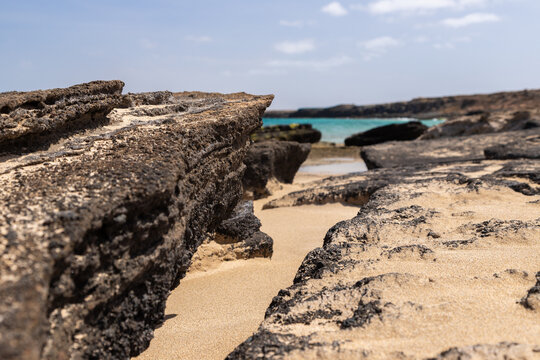 The beautiful white sandy beach with the unique sandscaped boulders on the waterfront of the Atlantic ocean near the village of Pedra de Luma on the island of Sal in Cape Verde. This kind of deserted 