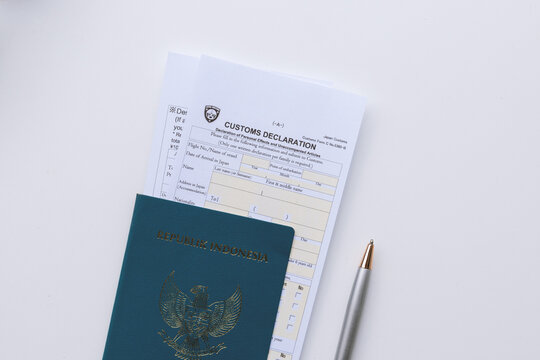 High angle view of Japan Customs Declaration Form C No. 5360-B inside a brown leather passport wallet isolated on white background