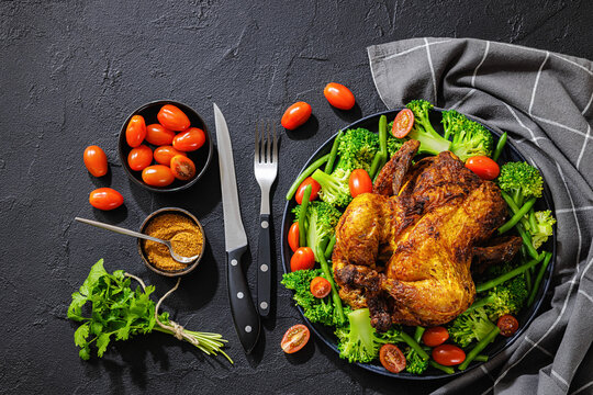 whole roasted chicken with veggies on a plate