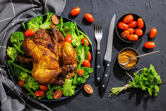 whole roasted chicken with veggies on a plate