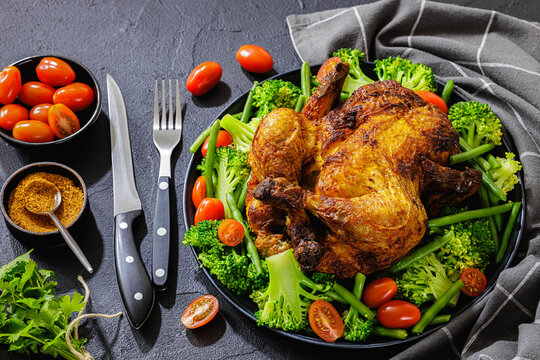 whole roasted chicken with veggies on a plate