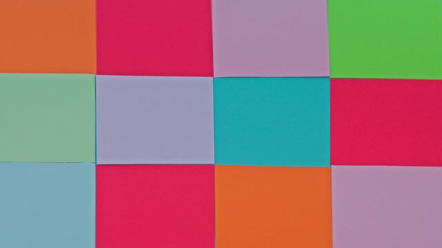 Slow Motion Video Of Hand Removing Red Crumpled Paper Ball From Grid Of Colorful Sticky Notes