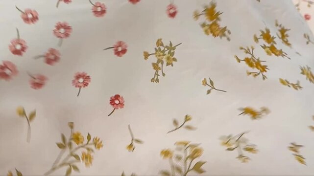 Elegant semi transparent textile featuring a dainty botanical print of small red flowers and yellow sprigs on a soft blush background ideal for spring fashion apparel and feminine accessories