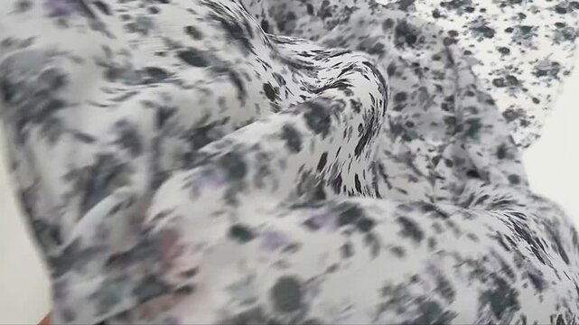 Exquisite sheer textile showcasing a vintage inspired ditsy floral print with purple roses and grey leaves on a white base perfect for elegant summer gowns feminine blouses and custom dressmaking