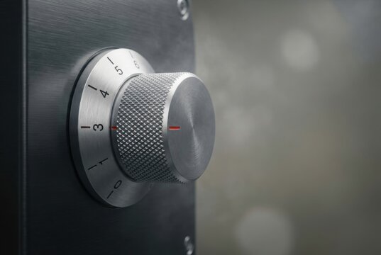 Metallic control knob on audio device. Rotary dial for volume or intensity adjustment. Industrial equipment interface for precision engineering, electronics and professional studio sound gear.